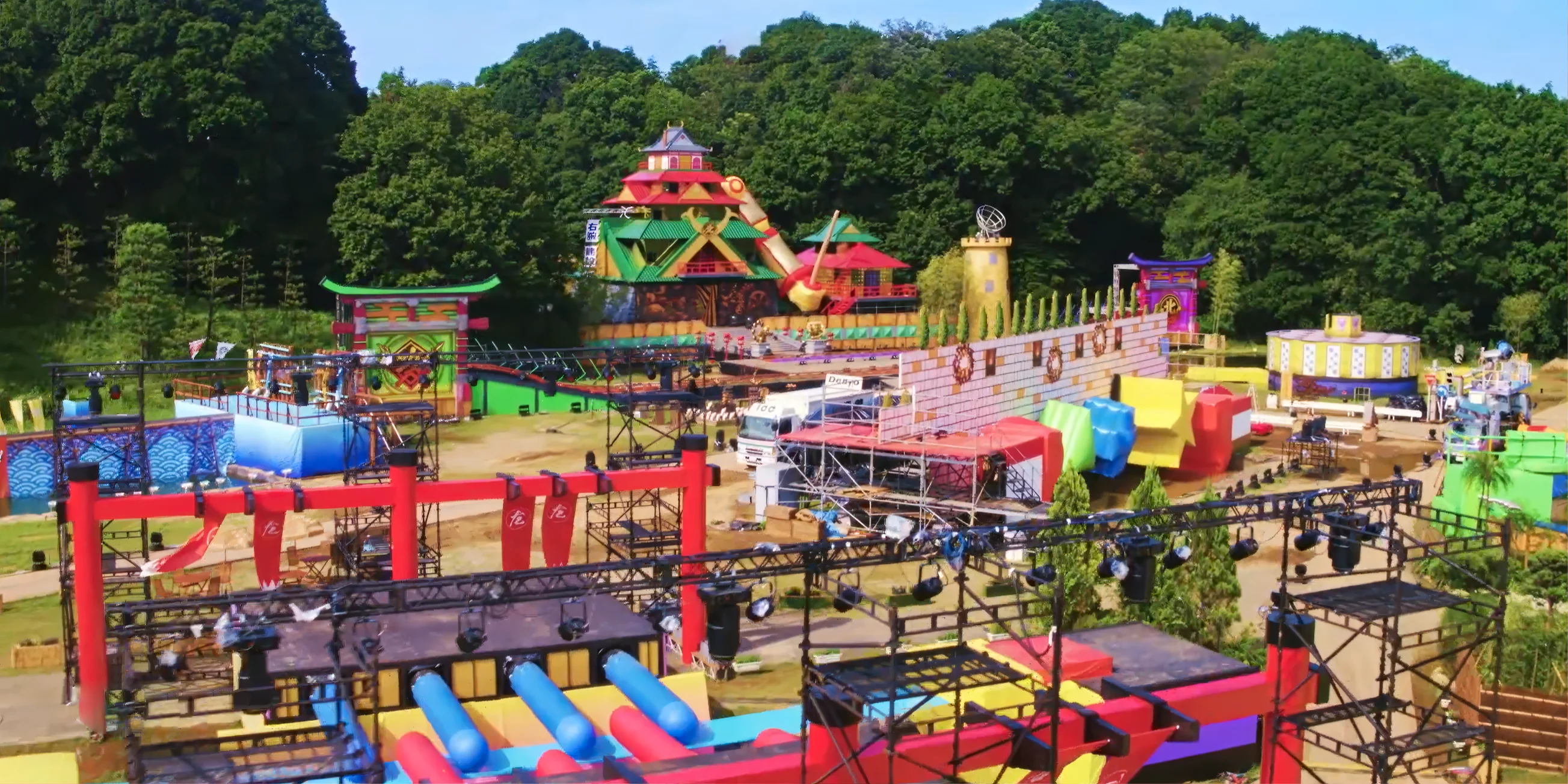 A long shot of the set of the 2023 Takeshi's Castle revival series, showing the grounds full of giant colourful games.